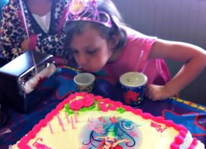 blowing out her birthday candles